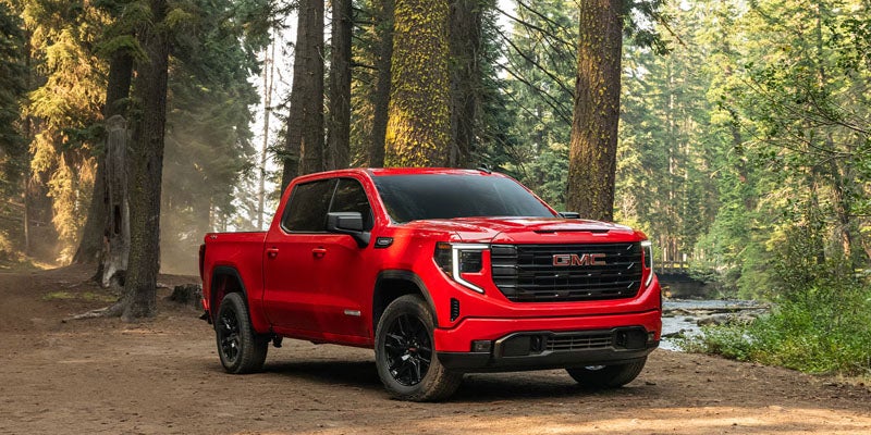 Red 2026 GMC Sierra 1500 parked outdoors with its bold side profile on display