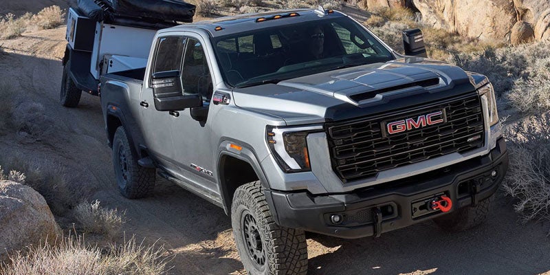 2026 GMC Sierra towing a large trailer, showcasing its impressive towing capability and power.